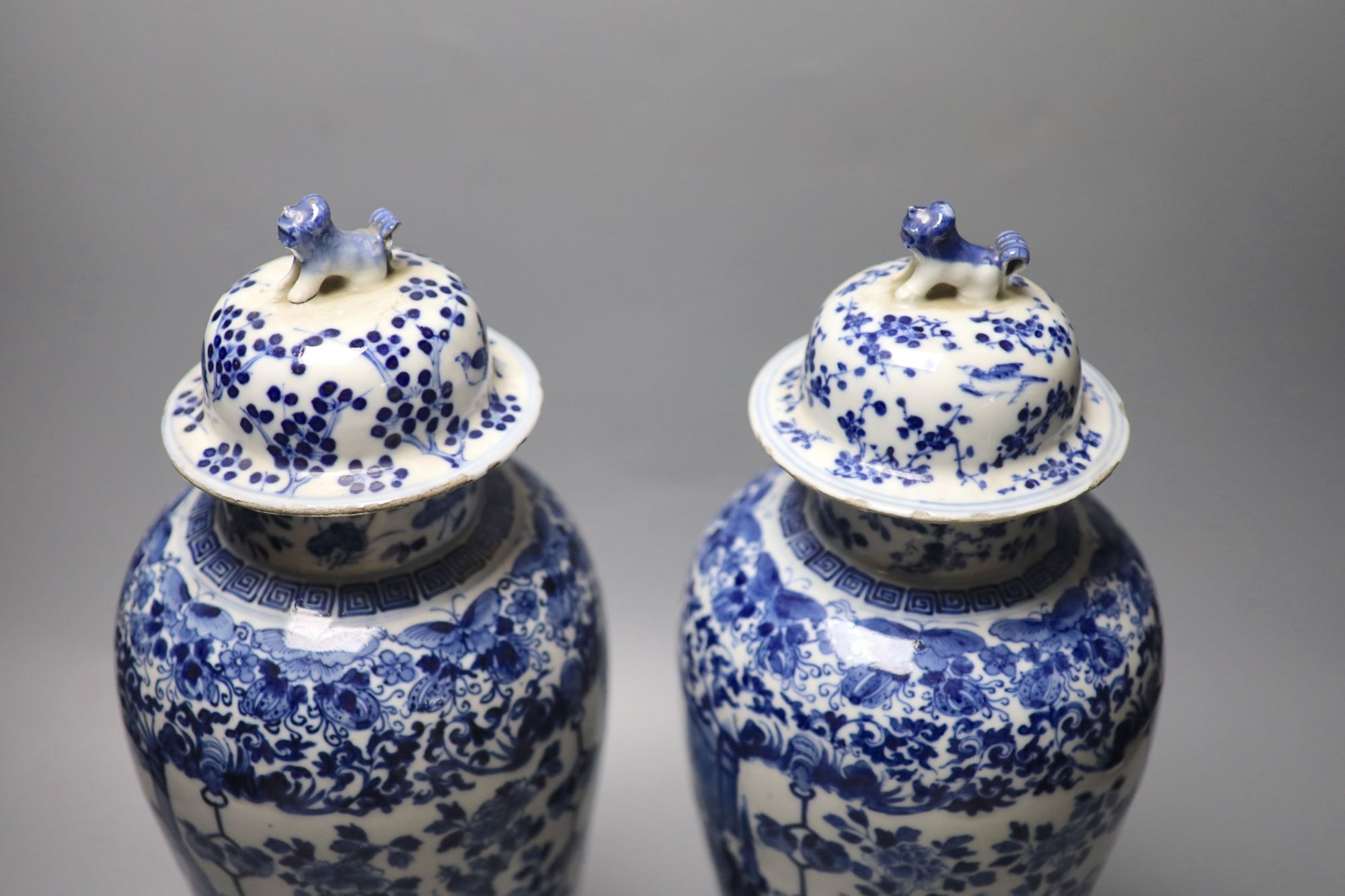 A pair of Chinese blue and white baluster vases and covers, Kangxi marks, late 19th century, 39.5cm high